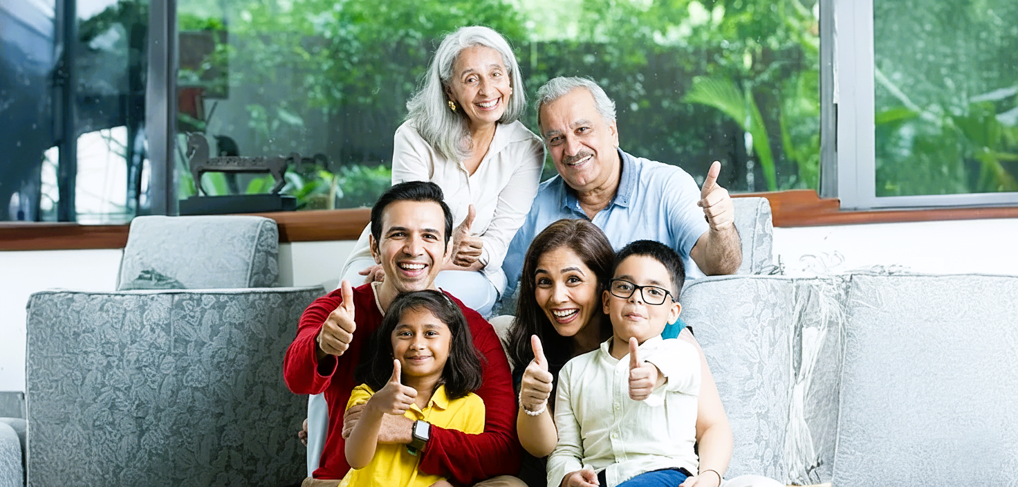 Happy family of four hugging and smiling in blue shirts